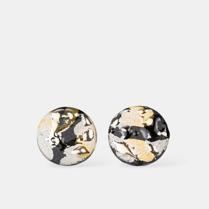 Pair of round porcelain earrings with gold and black marbled design by freakyfoxx on a white background