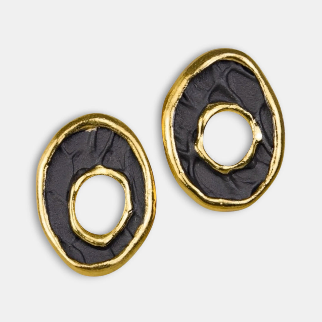 Pair of black and gold porcelain earrings by freakyfoxx on a light gray background