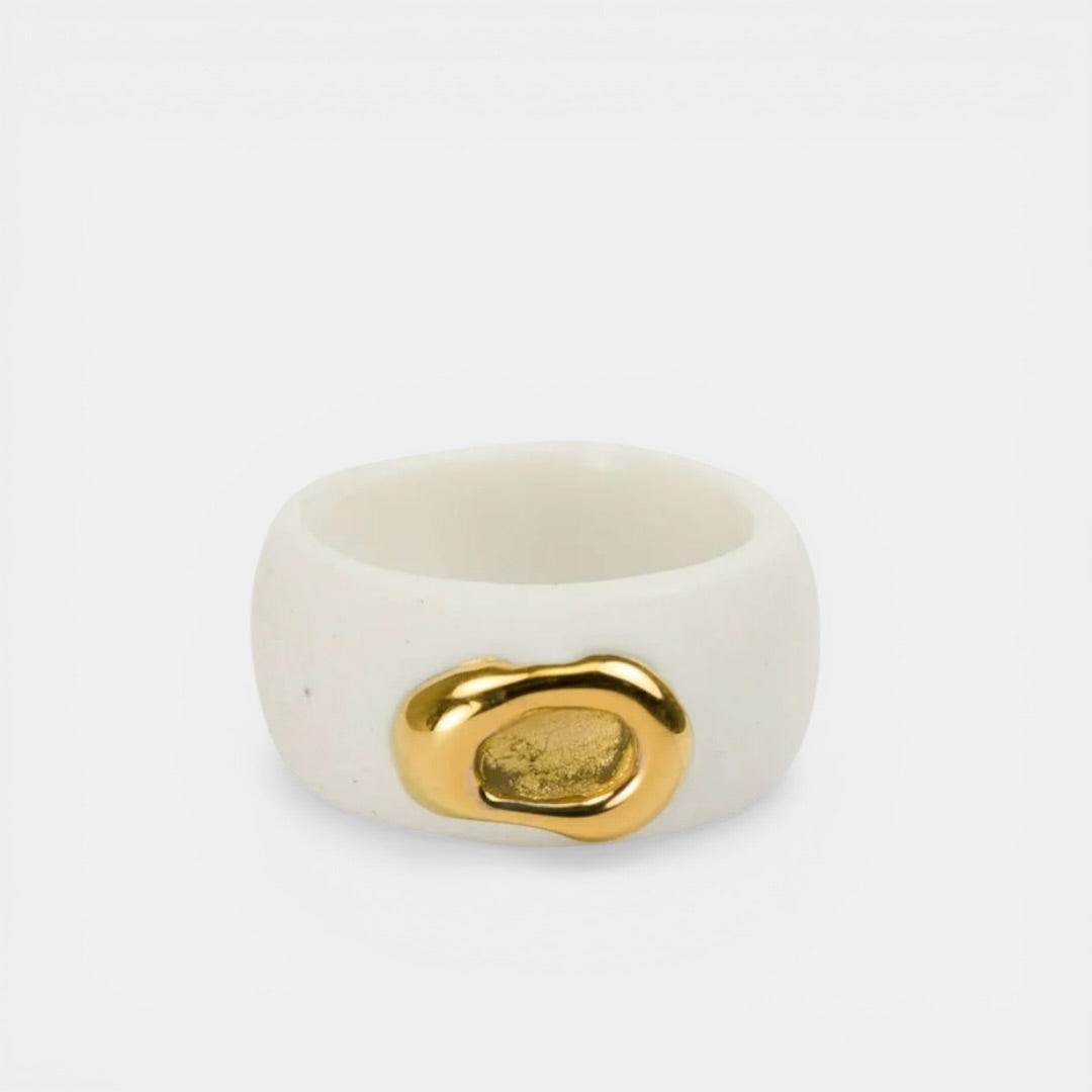 White porcelaim ring with a gold accent on a white background