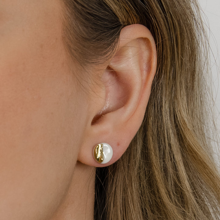 White porcelain earring with gold on ear