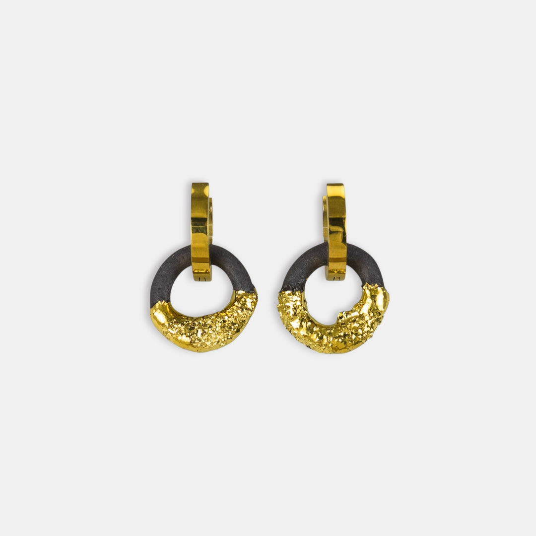 Pair of gold and black hoop earrings on a white background
