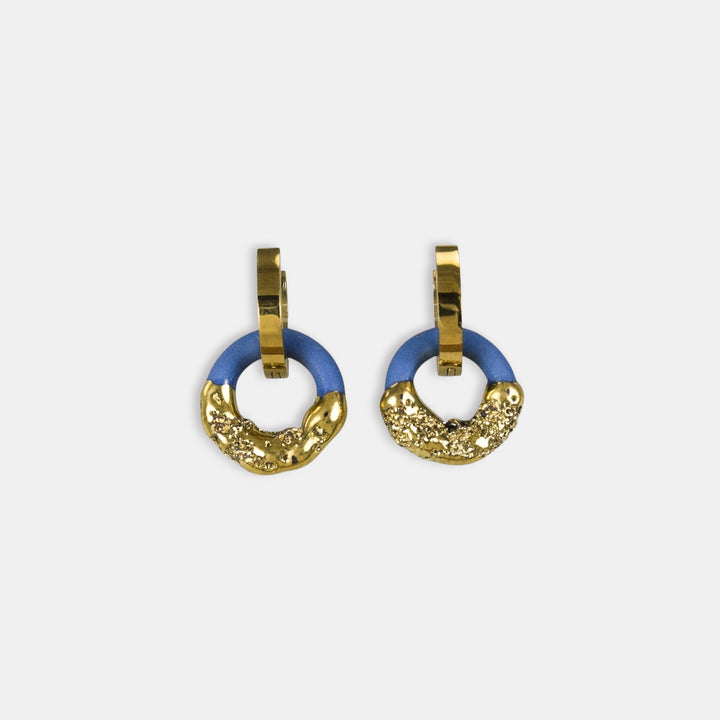 Pair of gold and blue hoop earrings by freakyfoxx on a white background