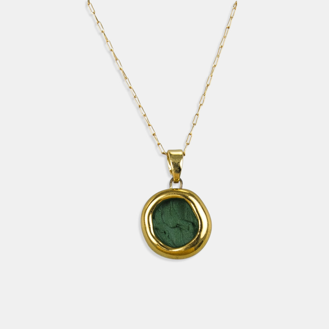 Gold necklace with a green porcelain pendant framed in gold on a white background by freakyfoxx