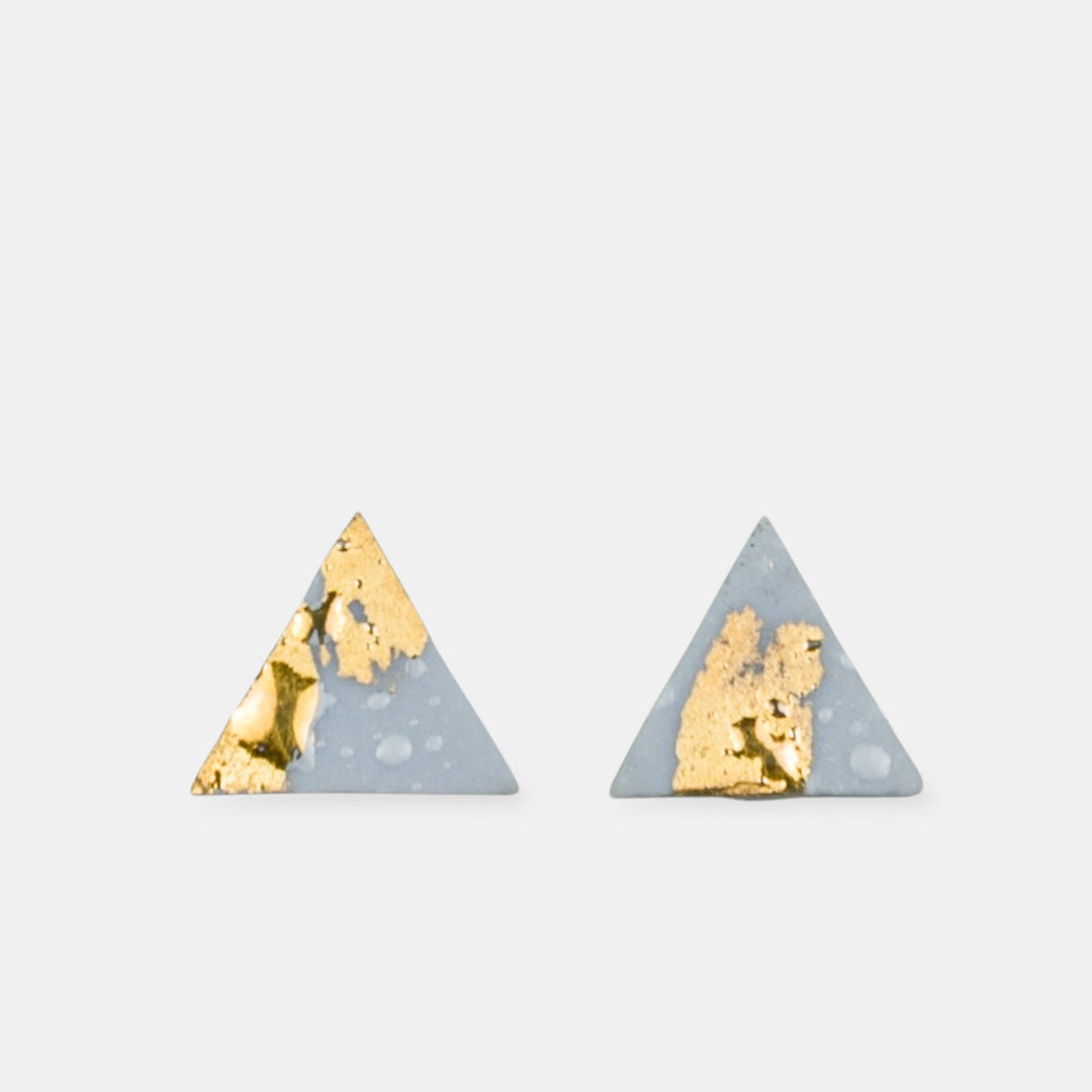 Triangle-shaped earrings with gold and light blue design by freakyfoxx on a light gray background.