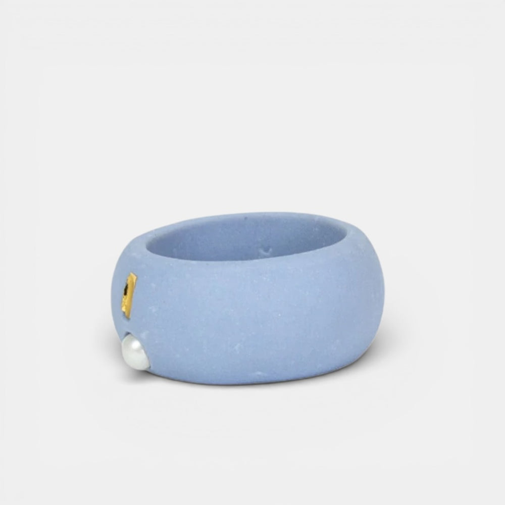 Light Blue porcelain ring with gold and gold accents on a light gray background