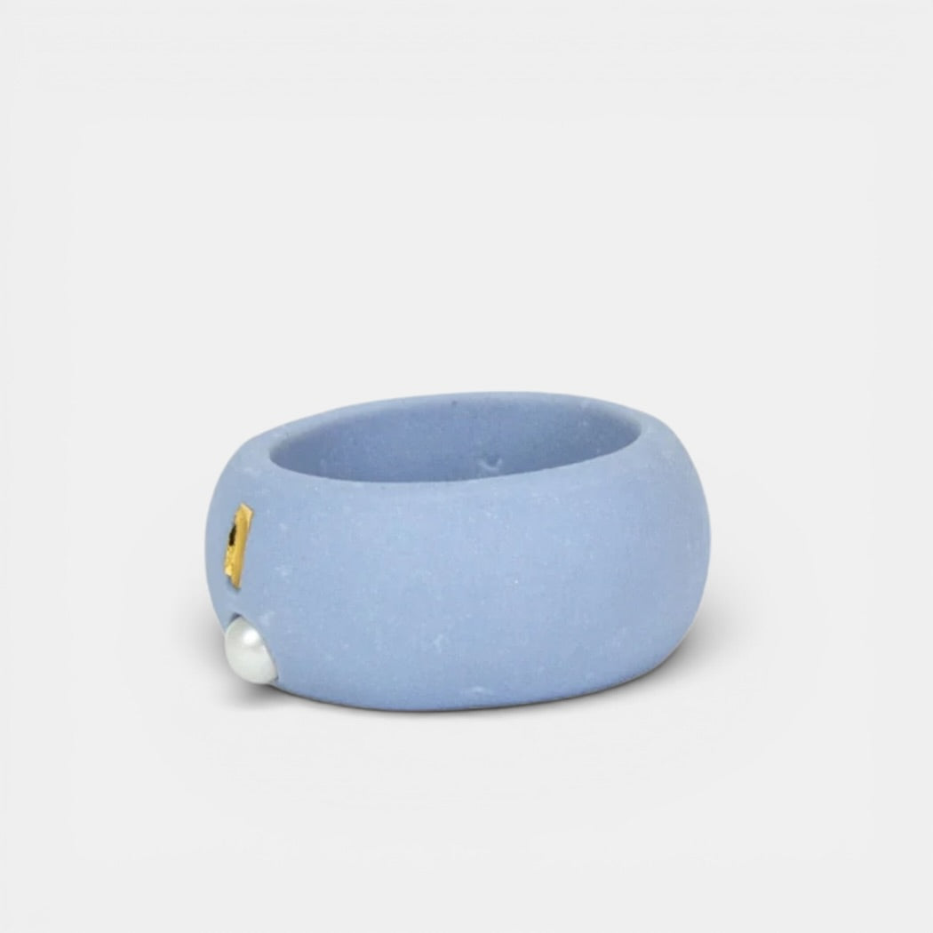 Light Blue porcelain ring with gold and gold accents on a light gray background