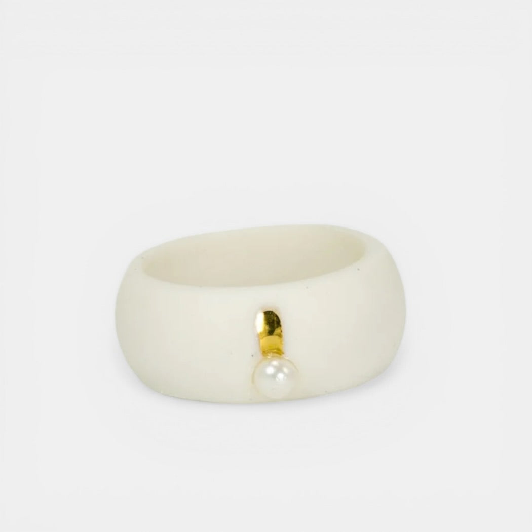 White ring with a gold accent and pearl on a white background