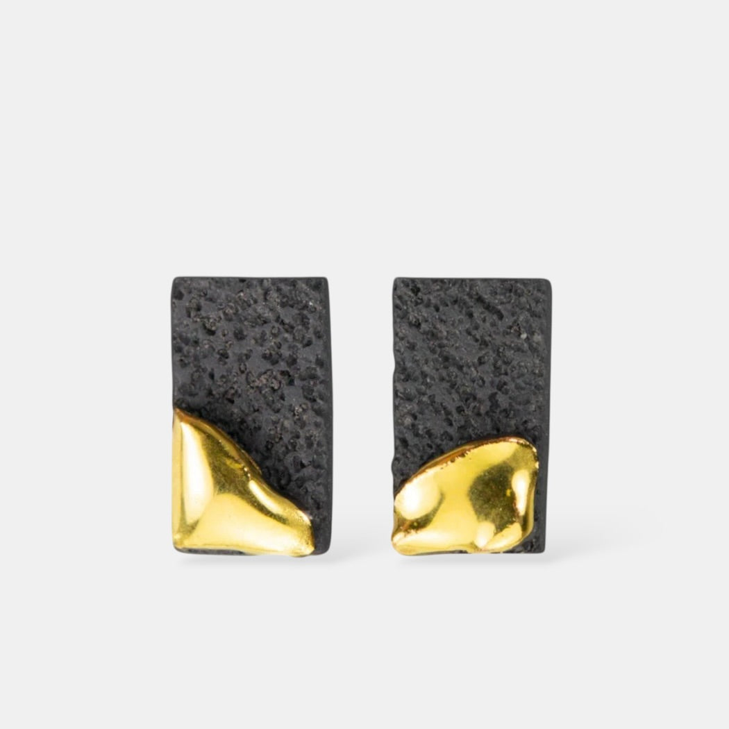 Pair of  black porcelain earrings with black textured design and gold base by freakyfoxx  on a white background