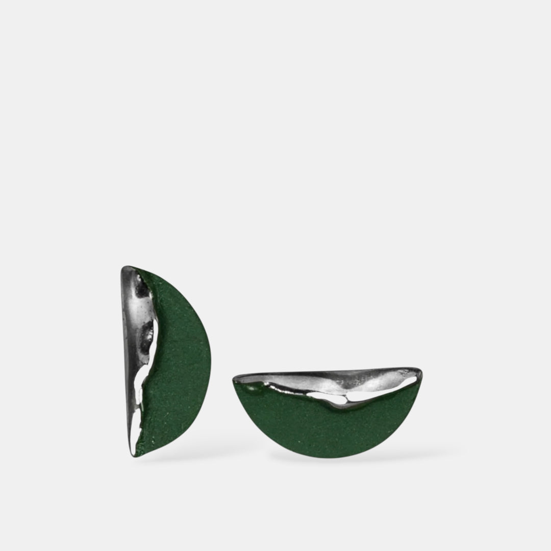 Green and silver half-circle porcelain earrings on a white background