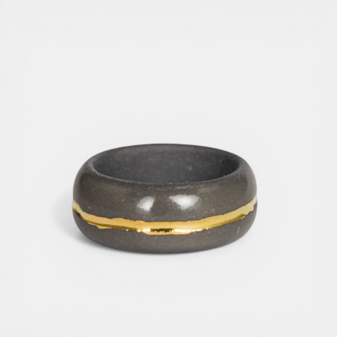 gray porcelain ring with a gold stripe by freakyfoxx on a white background