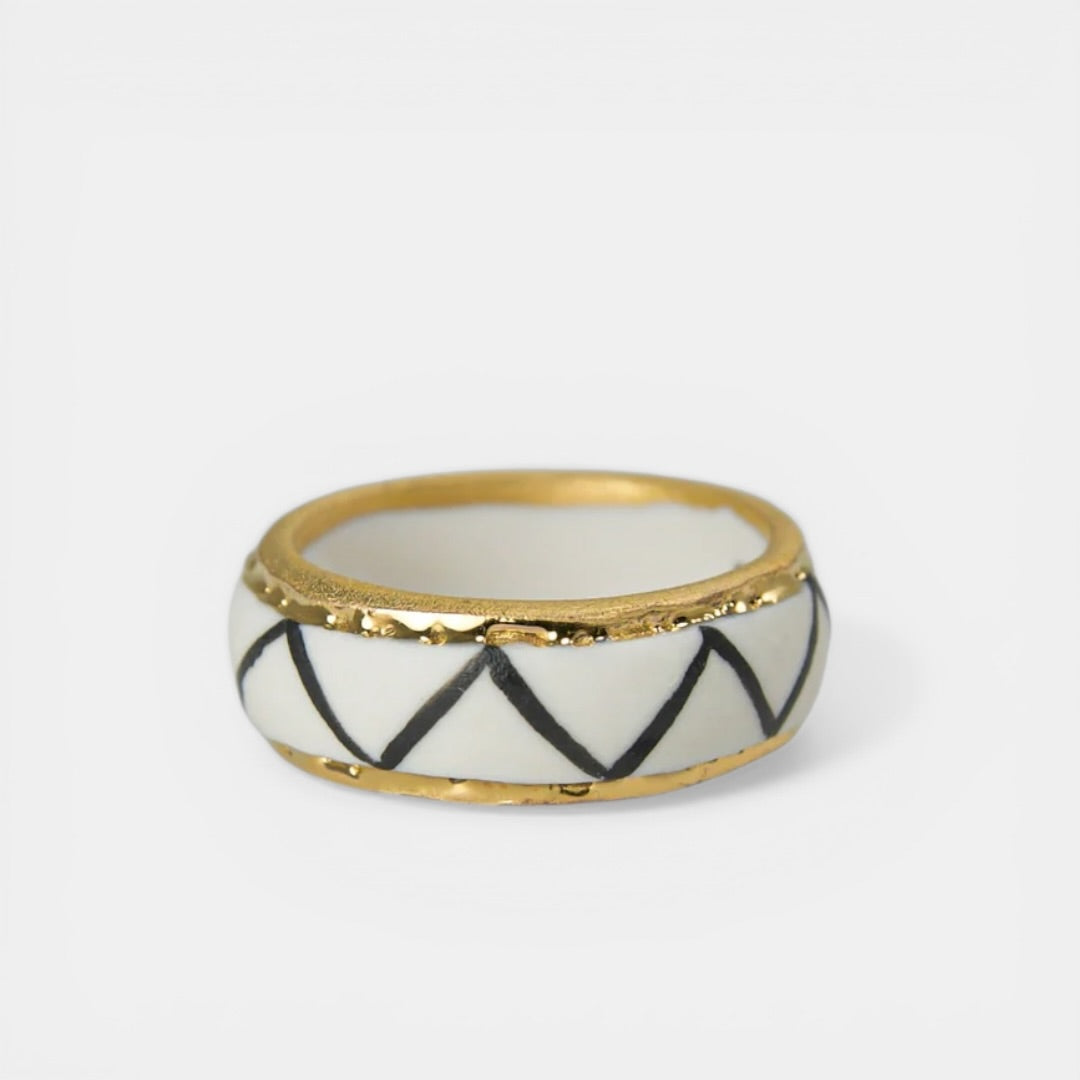 Ring with gold band and black and white pattern by freakyfoxx on a white background