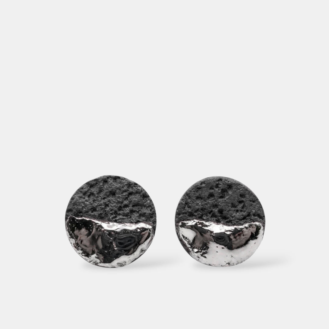 Pair of round black porcelain earrings with silver by freakyfoxx on a white background