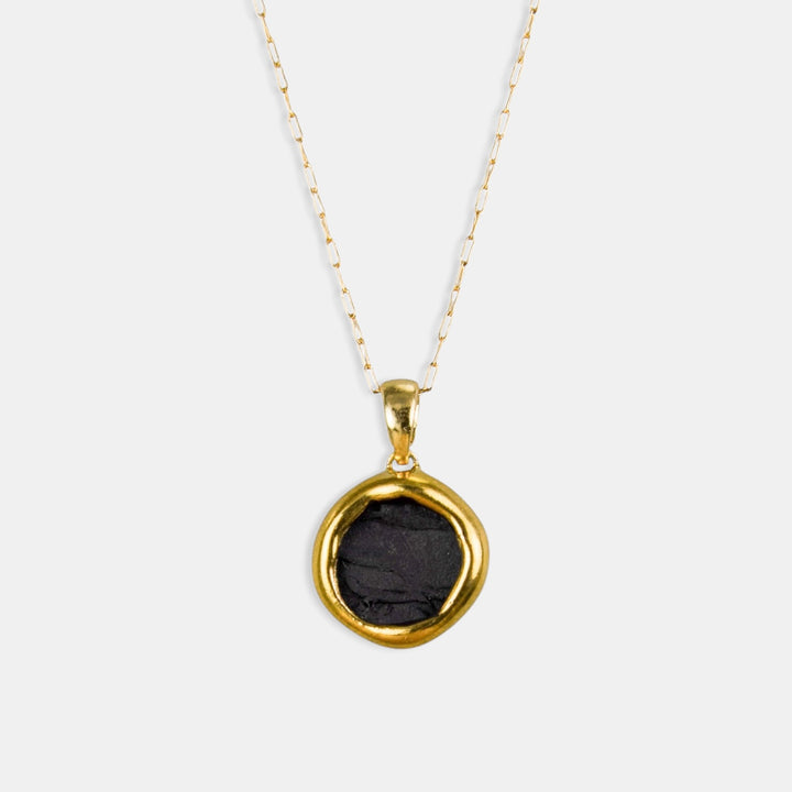 round matte black porcelain and gold pendant on gold chain by freakyfoxx