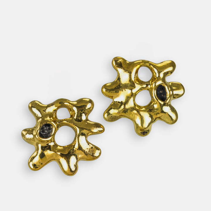 Gold sun shaped porcelain charms for hoop earrings by freakyfoxx with black gemstones on a white background