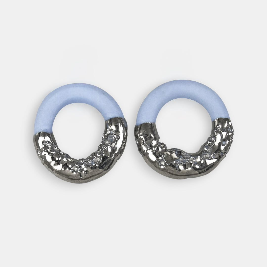 Pair of charms with light blue top and silver textured for hoop earrings on a white background