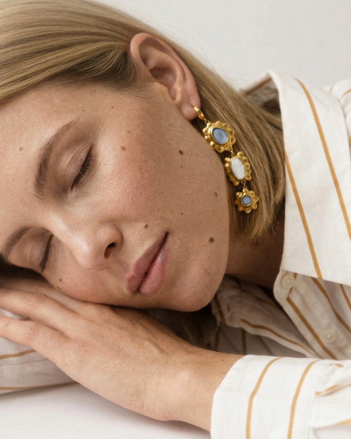 woman wearing handmade porcelain earrings with gold by freakyfoxx