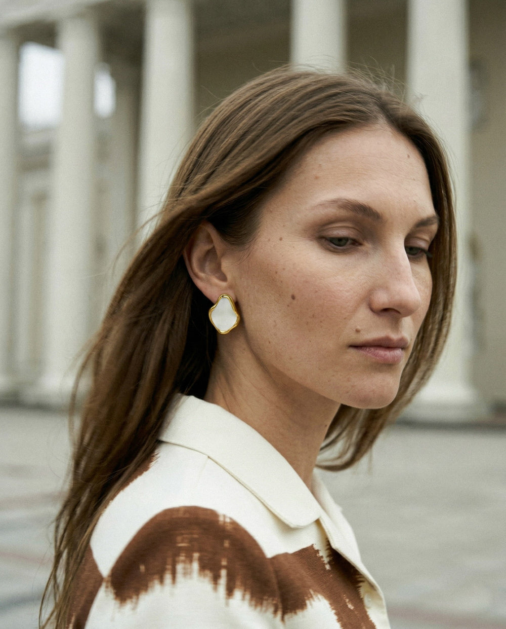 woman wearing handmade porcelain earrings with gold by freakyfoxx