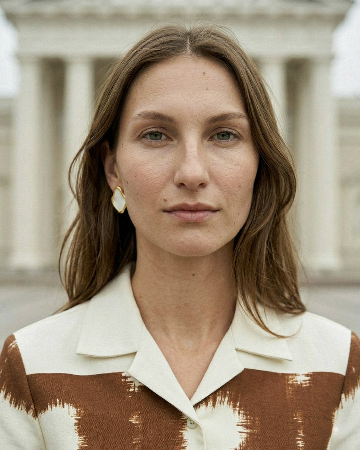 woman wearing handmade ceramic earrings with gold by freakyfoxx