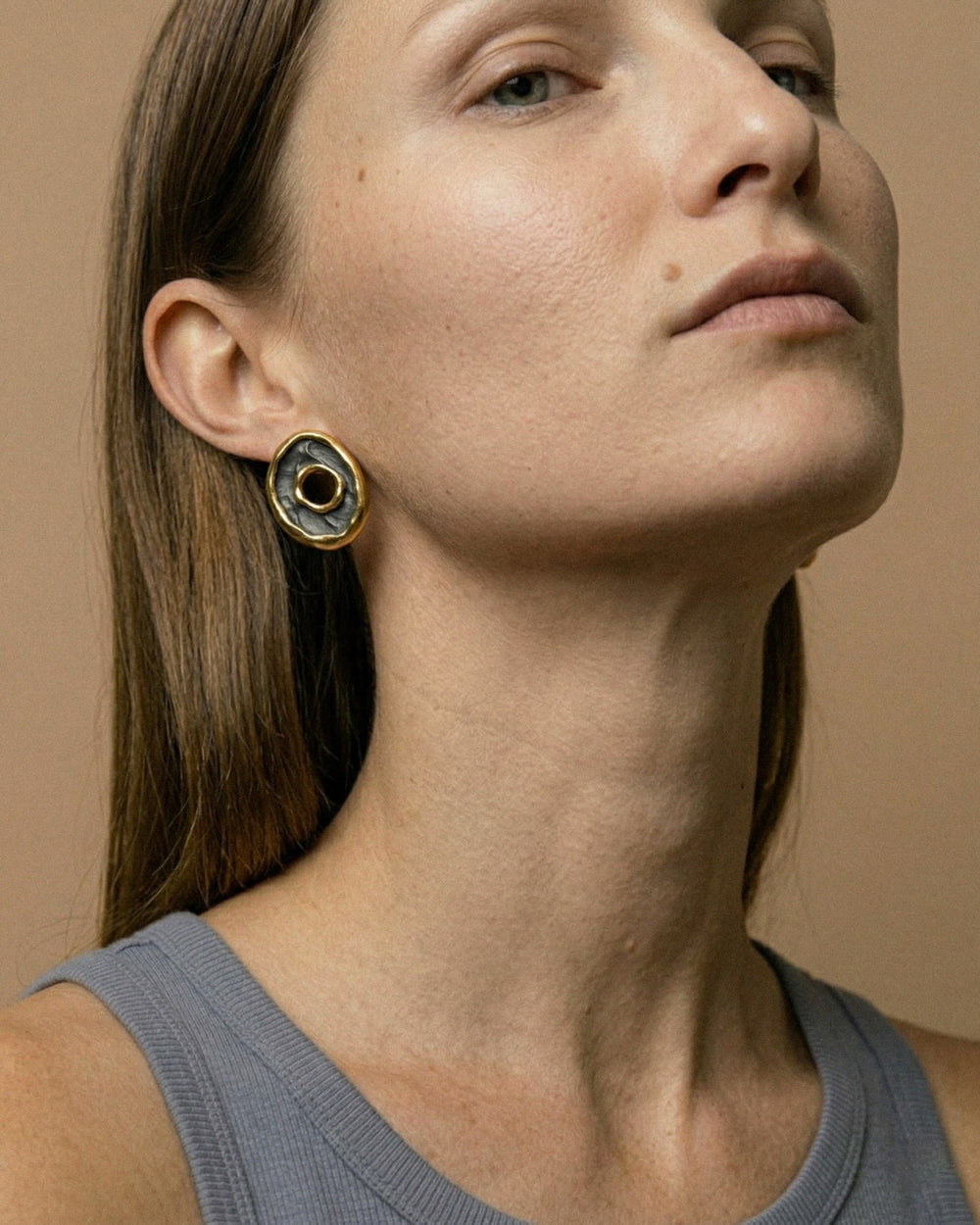 Moteris su juodu porcelianiniu auskaru su auksu iš arti (freakyfoxx)