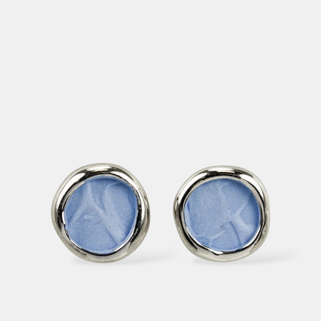 Pair of blue round porcelain earrings with silver rims on a white background by freakyfoxx