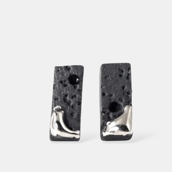 Pair of matte black textured bar earrings with platinum by freakyfoxx on a white background