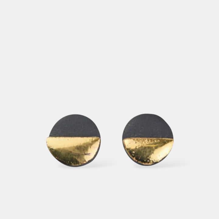 Black and gold half-circle porcelain earrings on a white background