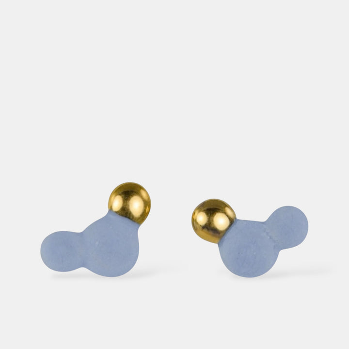 Pair of earrings with gold tops and blue bases on a white background