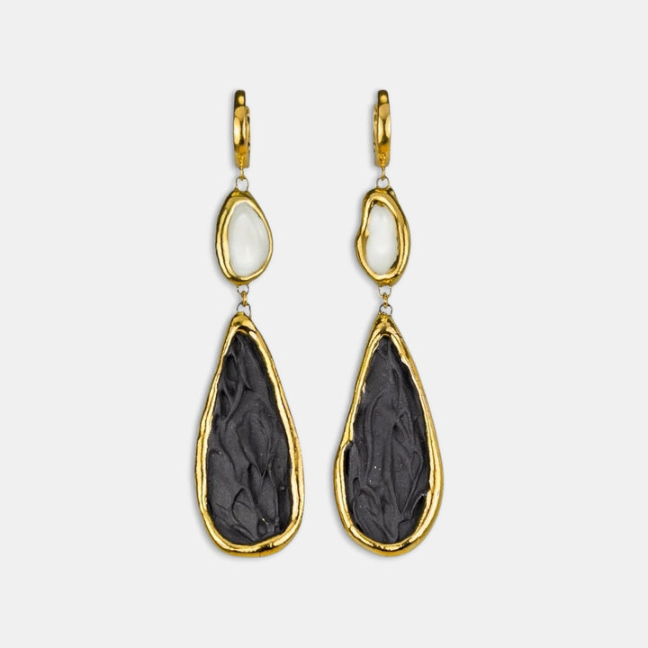 Pair of gold-framed earrings with black and white porcelain by freakyfoxx