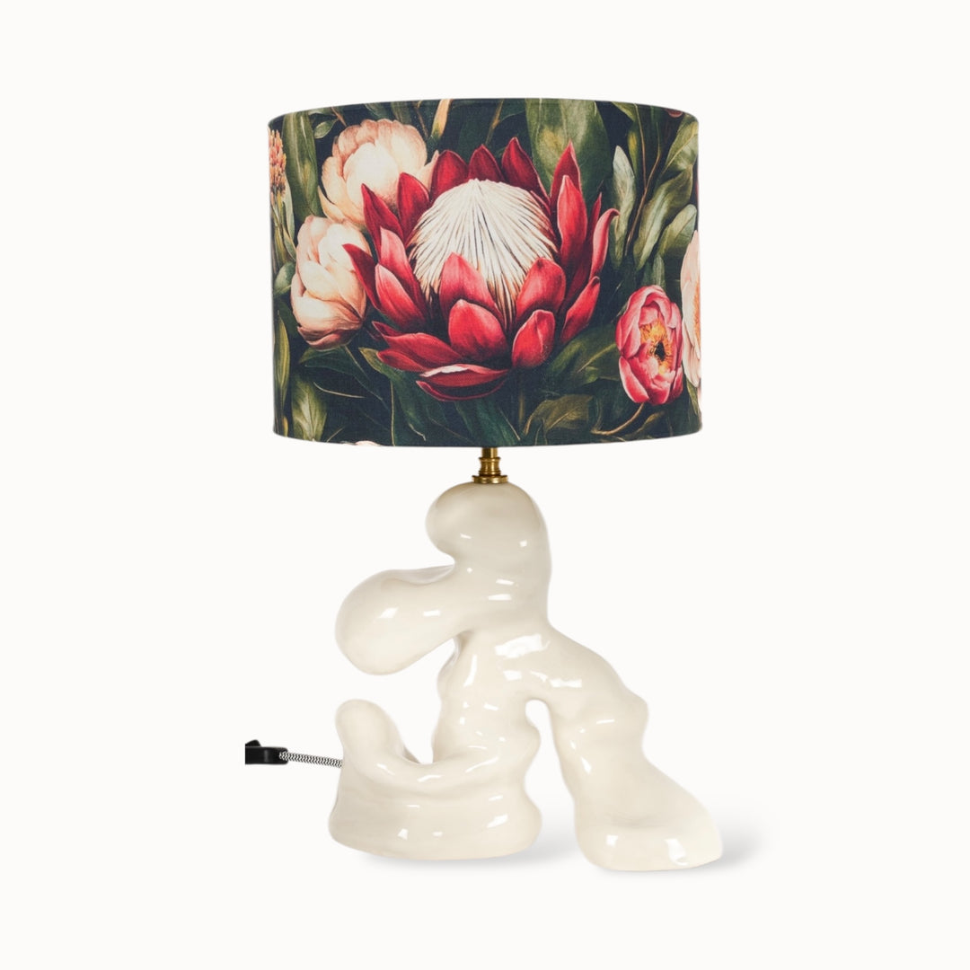 Handmade sculptural stoneware table lamp with a floral lampshade. A unique ceramic lamp base with an artistic, modern design. Ideal for contemporary home decor.