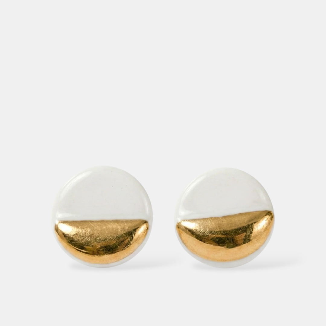 Pair of earrings with white and gold half-circle design by freakyfoxx on a light gray background