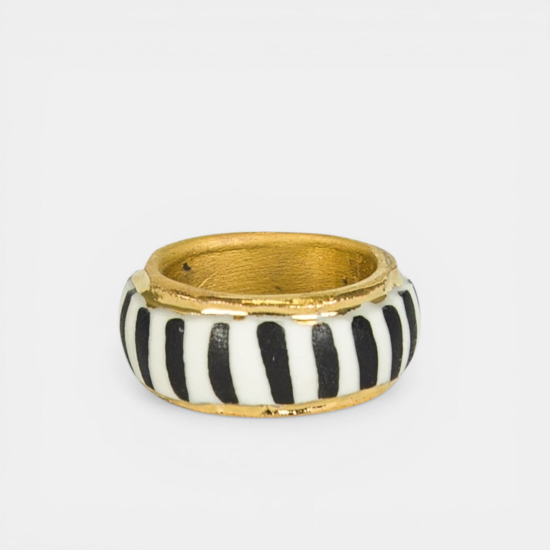 Porcelain ring with black and white striped band and gold by freakyfoxx  on a light gray background