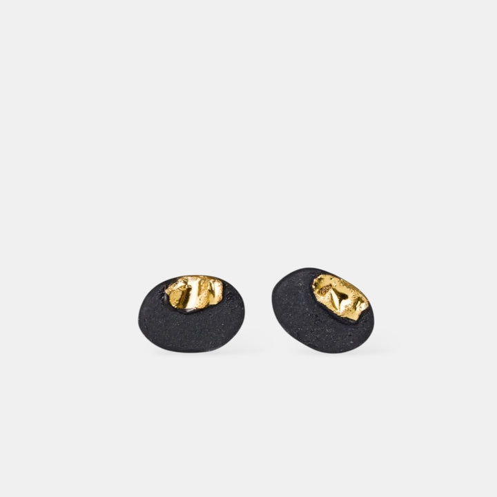 Pair of dainty black earrings with gold tops  by freakyfoxx on a white background